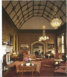 The Drawing Room at Tyntesfield with its barrel vaulted ceiling, looking toward the open doors to the Ante Room showing its ornate fireplace. 