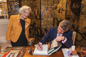 Royal Oak lecturer Jeremy Musson signs a copy of his book for Kathleen Buoymaster following his lecture in La Jolla, California