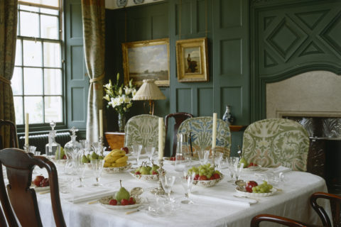 The Dining Room, looking over the table, set for dessert, at Standen, West Sussex
