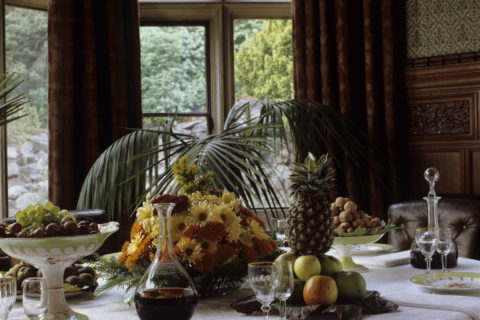 The dining table at Cragside, set for a dessert course with fruit and cheese