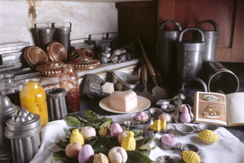 Victorian ice cream making utensils in the Larder at Petworth. Various delicious ice creams are ready to be devoured. Several different shaped moulds are on the shelves