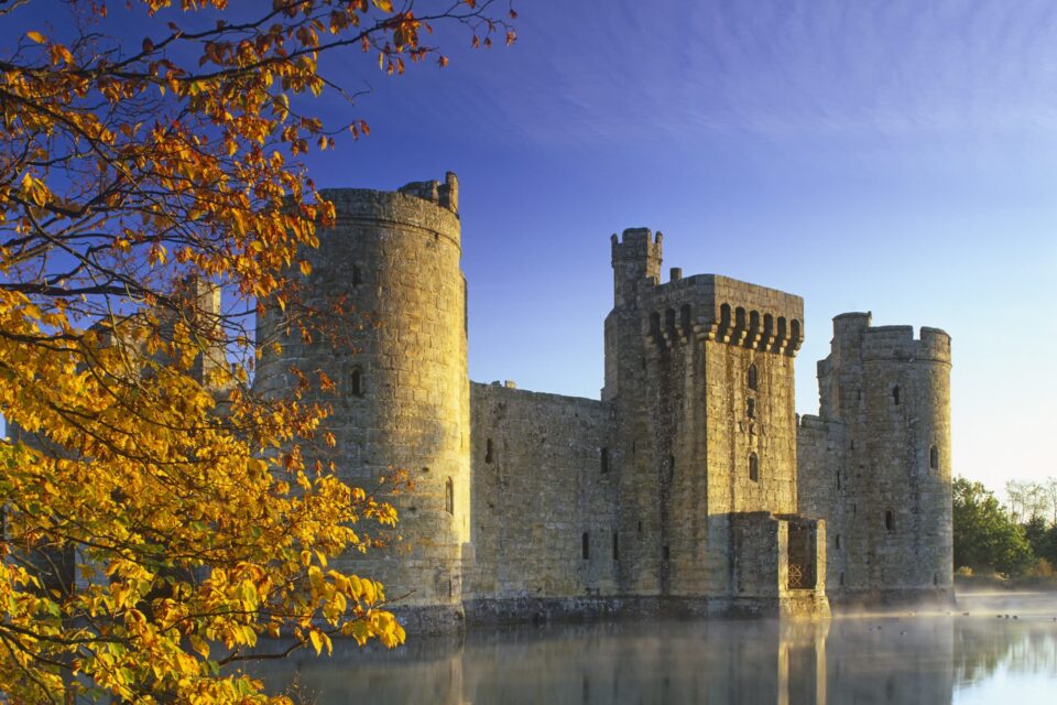 A slight mist rises from the moat at dawn at fourteenth century Bodiam Castle, East Sussex.. ©National Trust Images/David Sellman