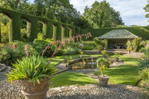 Large Cypress hedges line the edges of the Spanish Garden