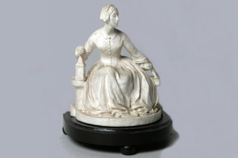 19th-century plaster model of Florence Nightingale sitting on a bench and holding a lamp, Hardwick Hall