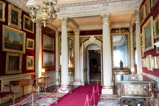 The Velvet Drawing Room at Saltram. The pier glasses and tables were designed by Adam in 1771 and made by Perfetti.